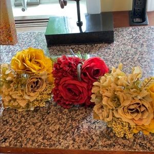 3 small floral bouquets, one red and 2 golden.